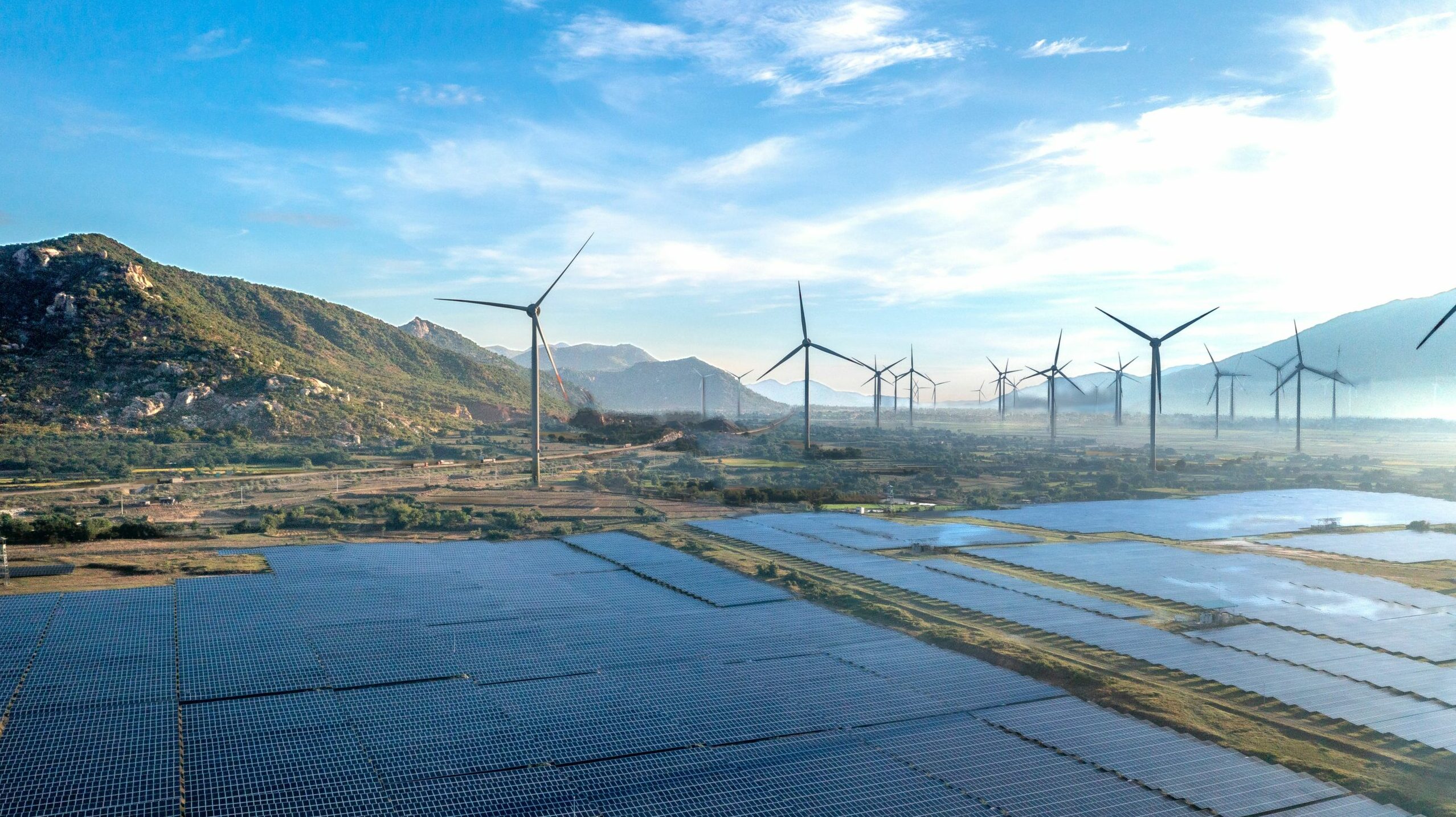Aerial view of wind turbines and solar panels